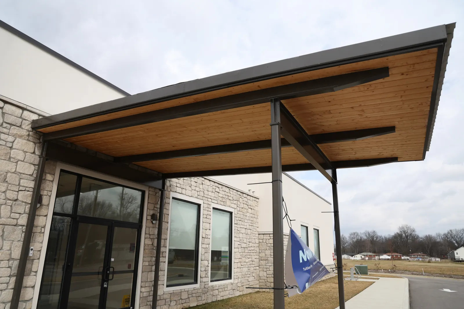 The metal-roofed entrance canopy at Bezos Academy, Louisville