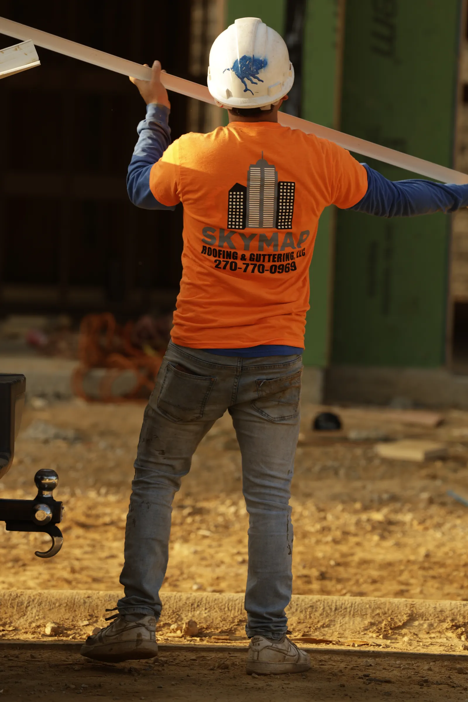 A Skymap crew member carrying lumber on the Buffalo Ridge site