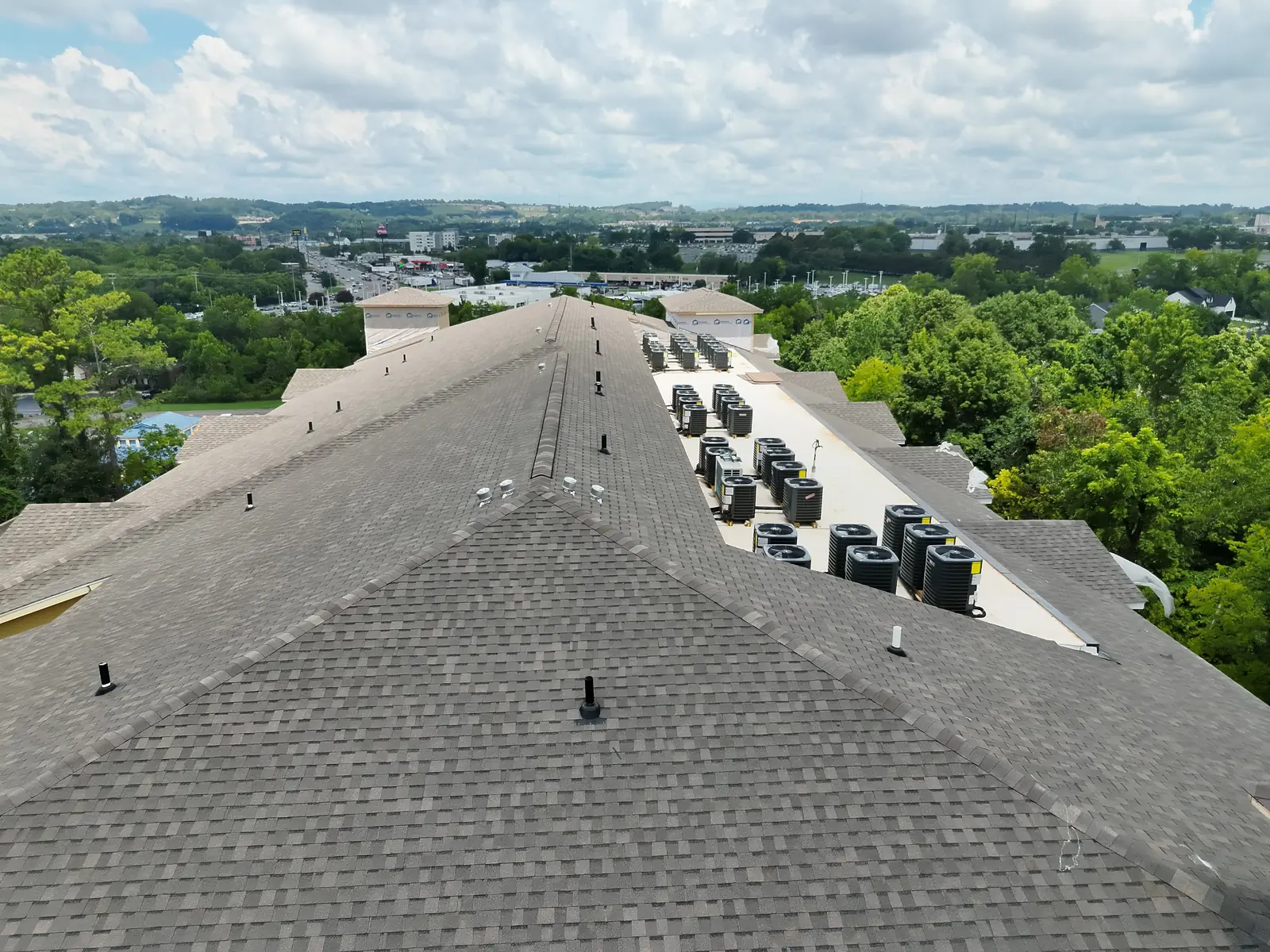 A low-slope roof section with rooftop units